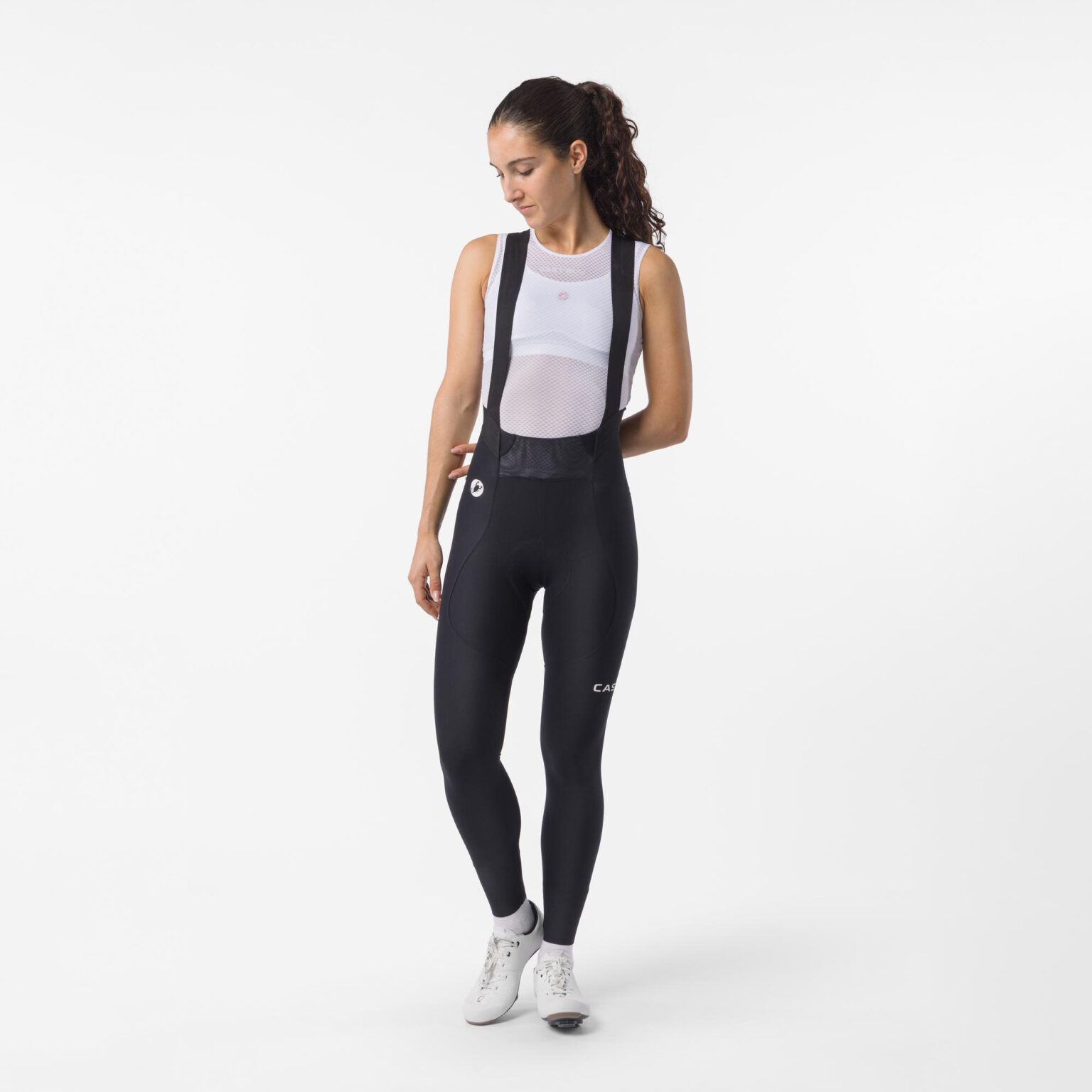studio image of a woman wearing the Espresso TRNSTN bibtights