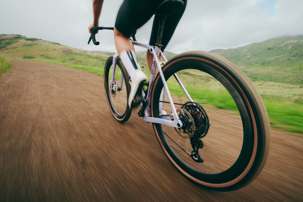 a woman riding with the new WTB CGR i28 wheels on a gravel road