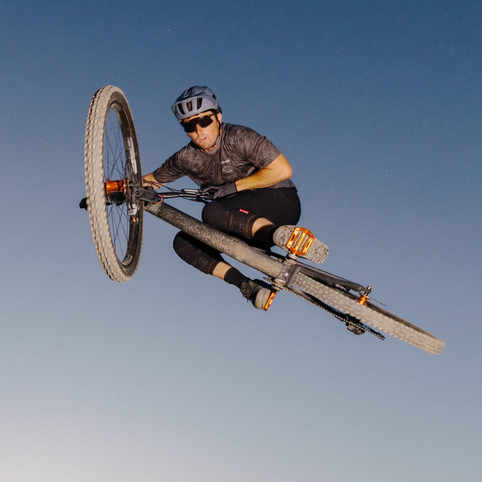 a rider in the air on a bike with the Wolf Tooth J-Bend hubs