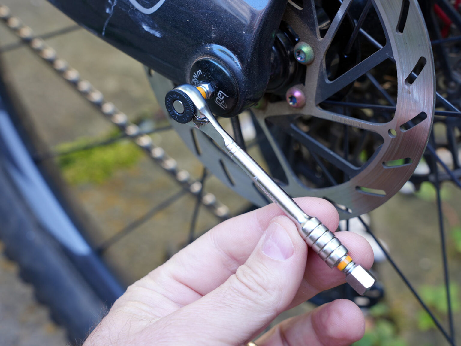 granite stash rt mini tool being used for bicycle repairs.