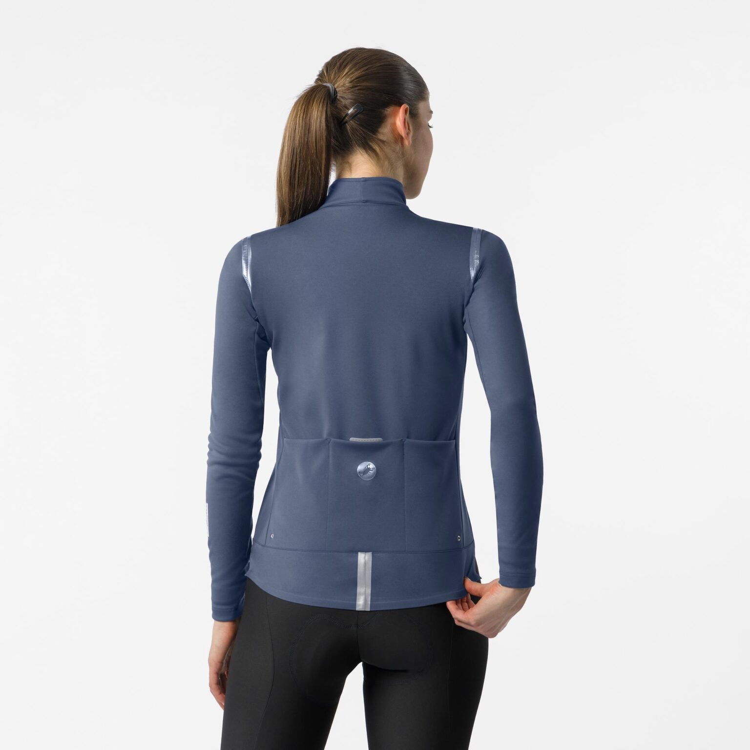 studio image of a woman standing wearing the new Castelli Perfetto 4 jacket viewed from the rear