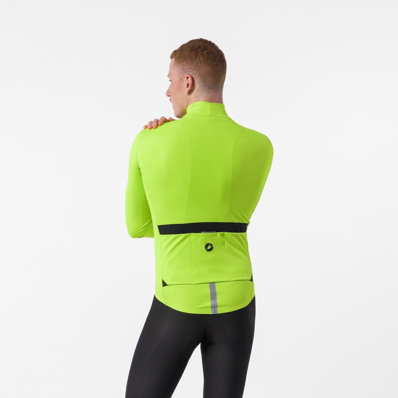 studio image of a man standing wearing the new Castelli Perfetto Pro jacket viewed from the rear