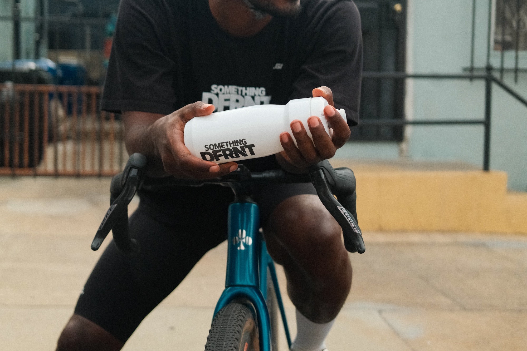 a man holding a custom CamelBak water bottle