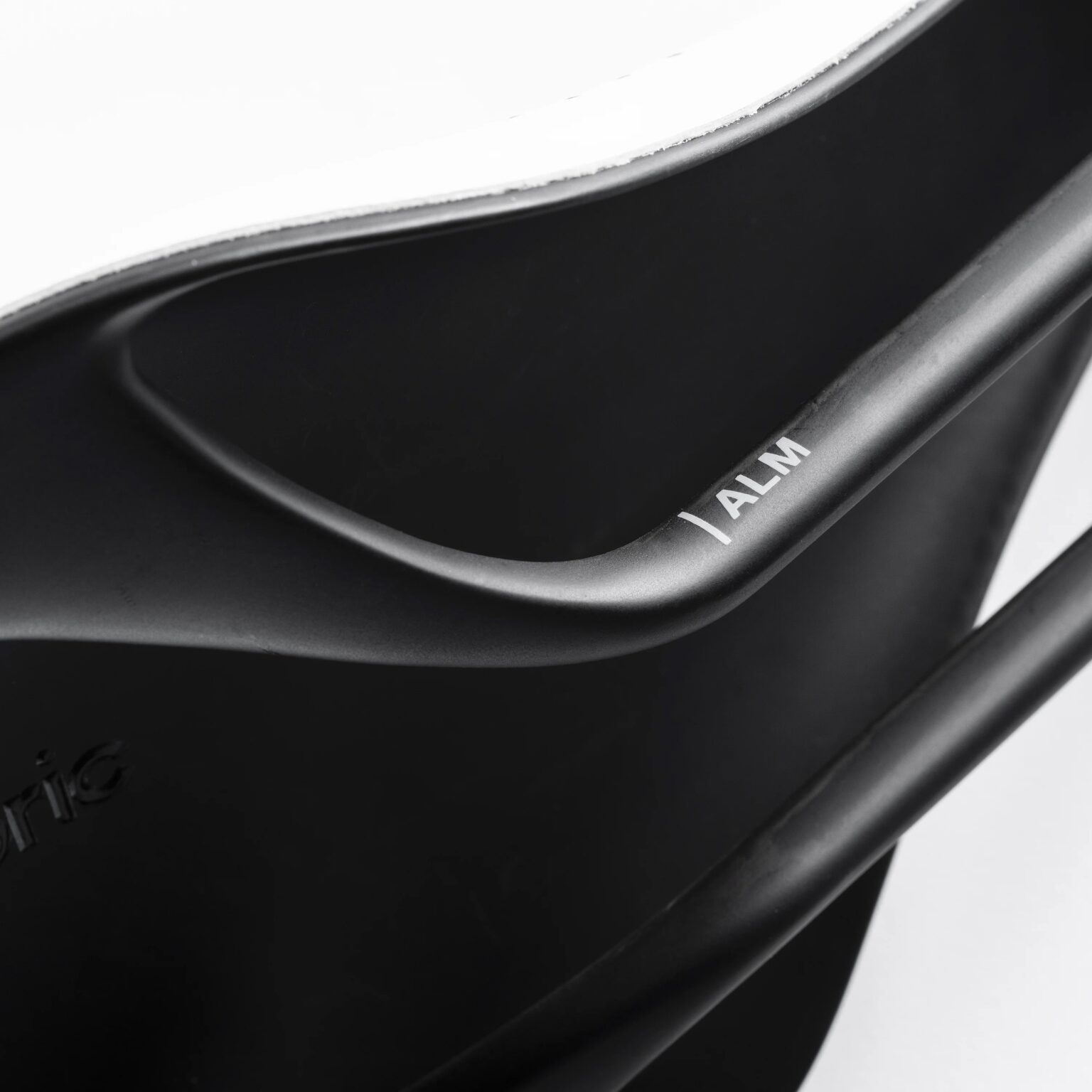 studio image of the Fabric ALM:HALO bike saddle shwing detail of the carbon rails