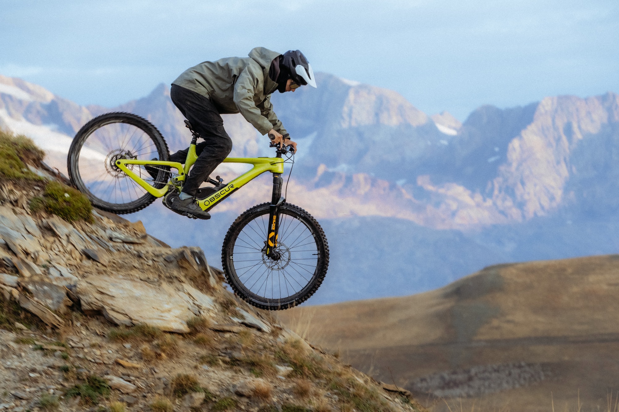 a rider on the Obscur Enyx with mountain in the background.