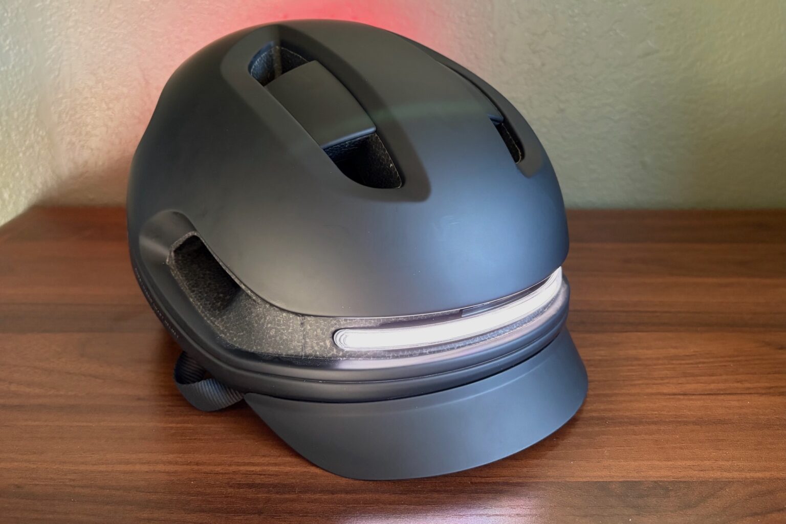 the Unit 1 Aura helmet viewed from the front angle with the light on