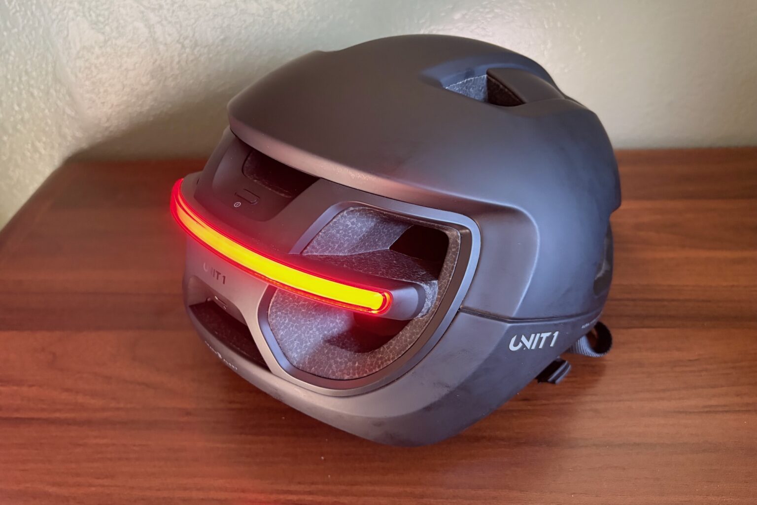 the Unit 1 Aura helmet viewed from the rear angle with the light on