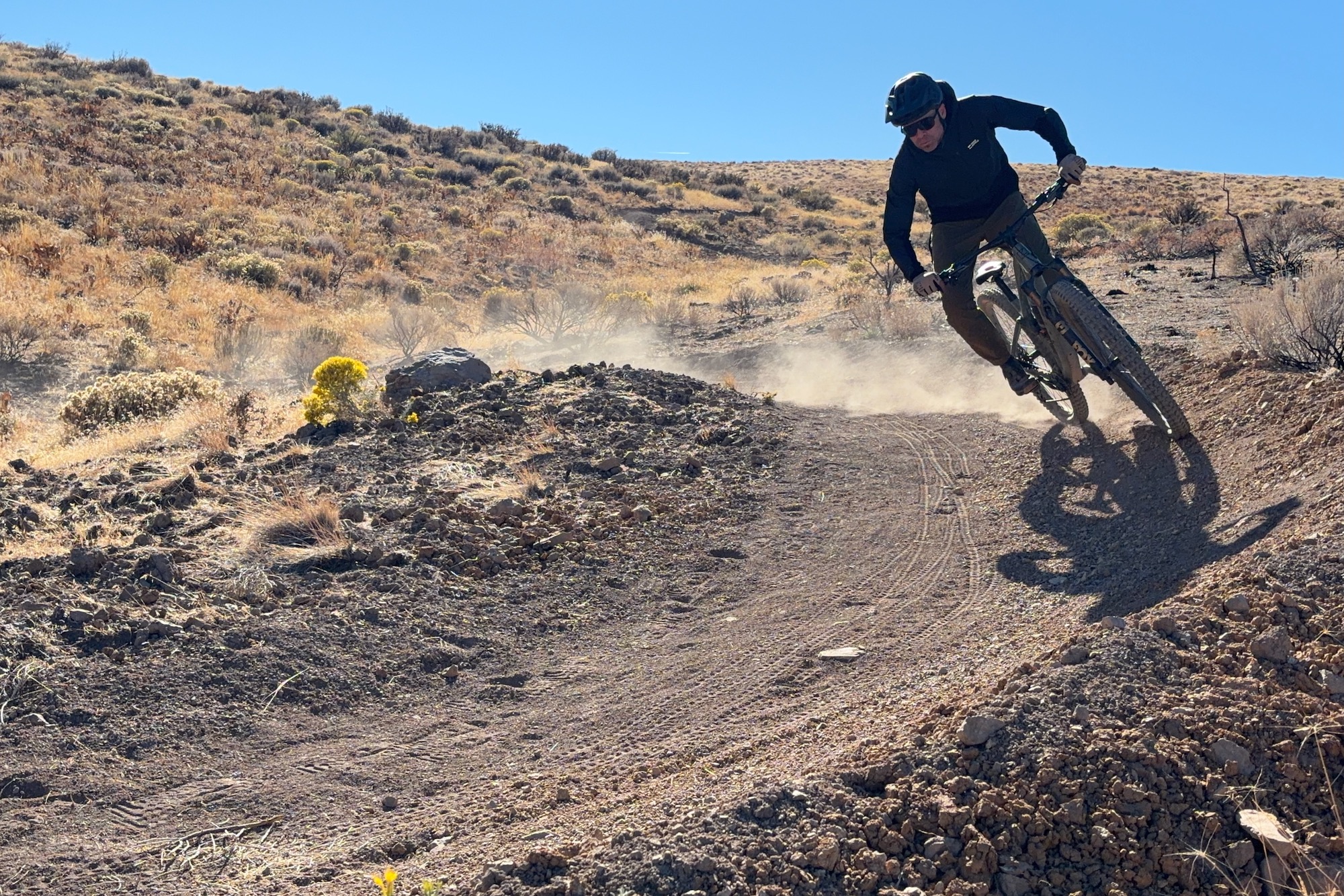 riding around a bermed turn while wearing the Mons Royale Diversion pants and jacket